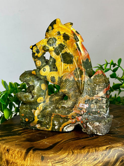 Large hand-carved Eighth Vein crystal dragon with natural druzy pockets and green, gold and orange mineral patterns