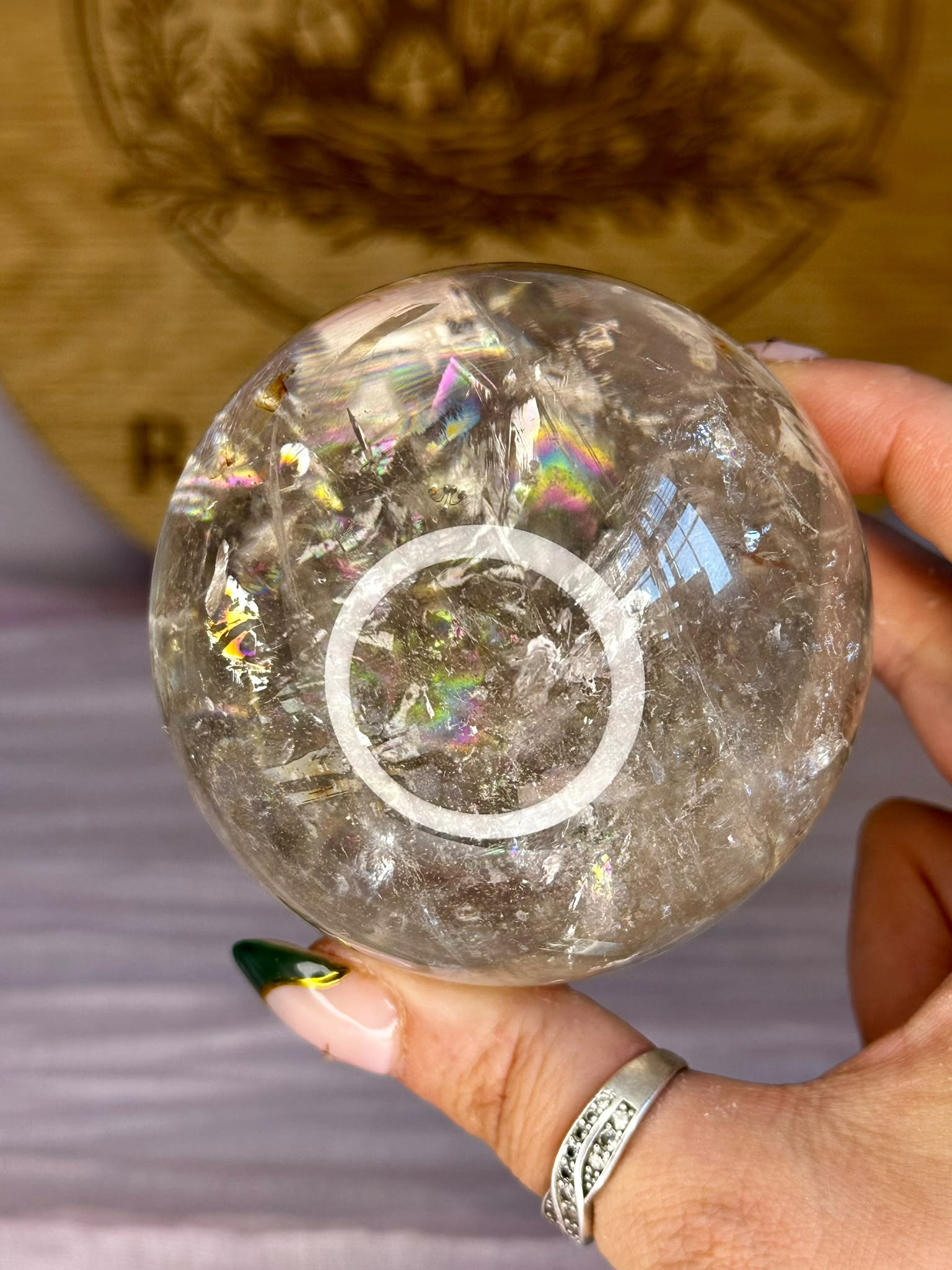 Natural Smoky Quartz rainbow sphere from Pakistan with vibrant internal rainbow inclusions.