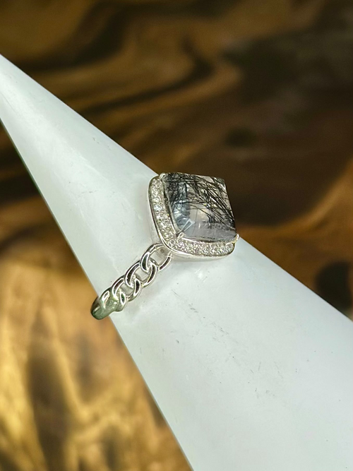 Angled view of Black Rutilated Quartz sterling silver ring showing dark needle inclusions and silver band detail