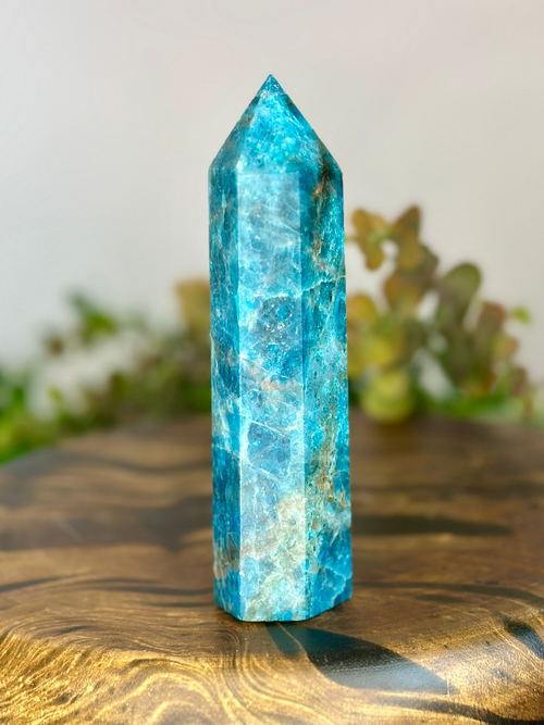 Side view of polished Blue Apatite tower showing bright blue crystalline detail and natural inclusions.