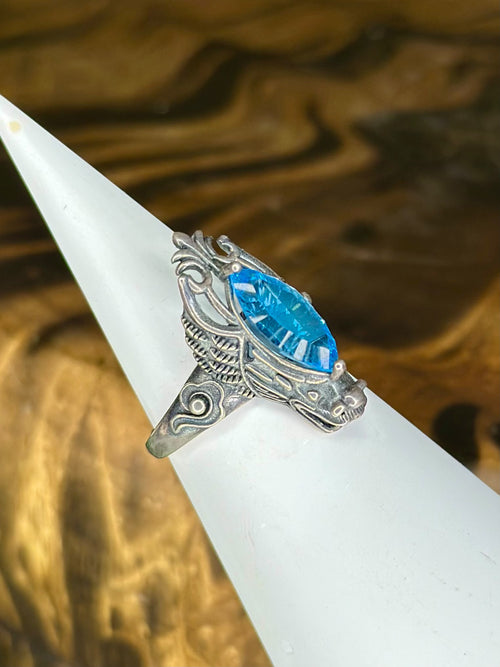 Side view of ornate Blue Topaz dragon crystal ring