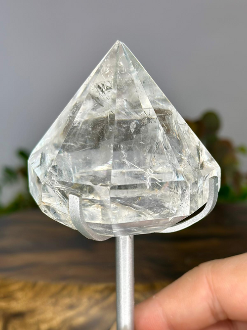 Close-up of polished Brazilian Clear Quartz diamond showing natural internal fractures and clear faceted structure