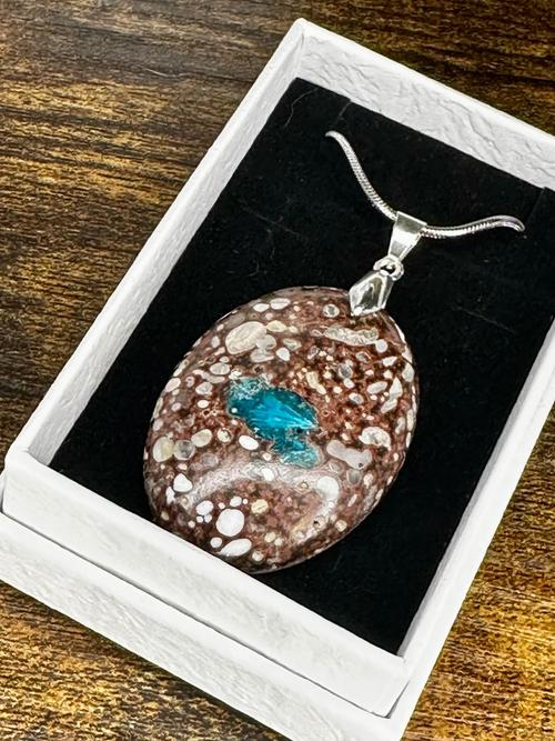 Polished Cavansite pendant featuring vivid electric-blue Cavansite within a contrasting brown, cream and rust-toned natural matrix