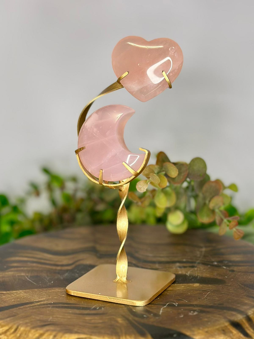 Celestial Rose Quartz moon and heart carving displayed on elegant gold metal stand