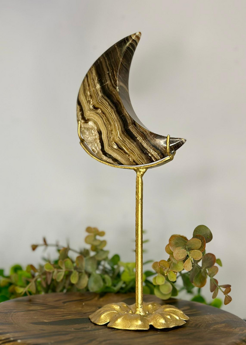 Reverse of polished Chocolate Calcite crescent moon showing natural layered banding on gold stand