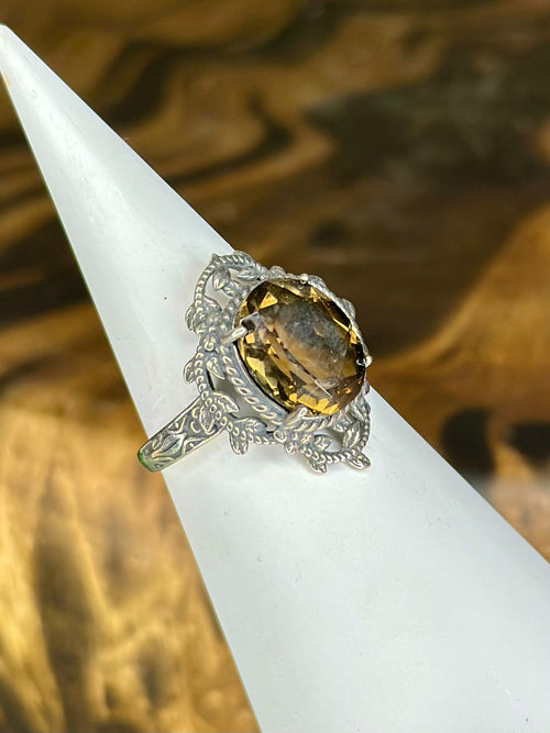 Side view of Citrine ring with ornate silver-tone botanical setting