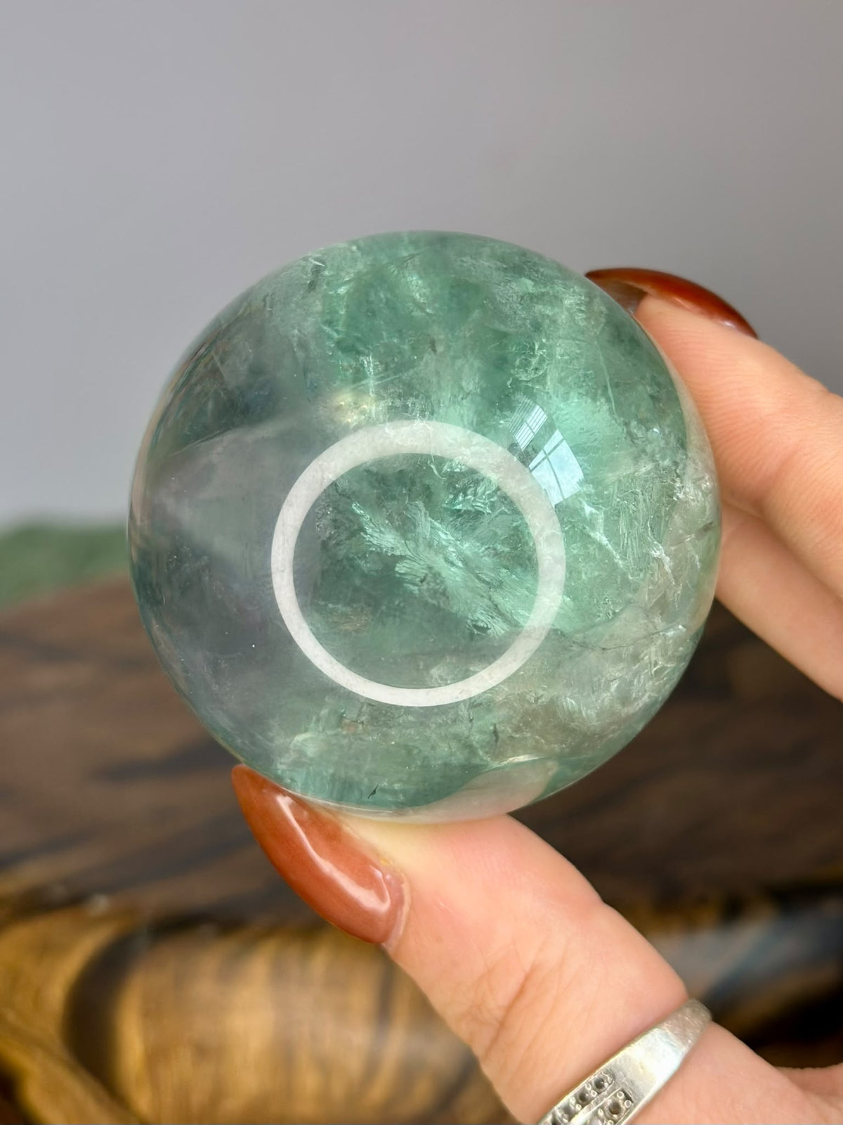 Translucent Green Fluorite crystal sphere showing natural internal patterns, 5.5cm