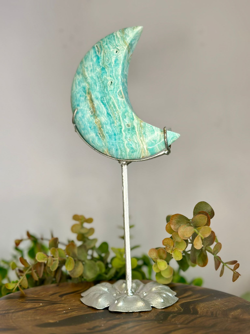 Reverse of polished Blue Aragonite moon showing natural turquoise wave-like banding