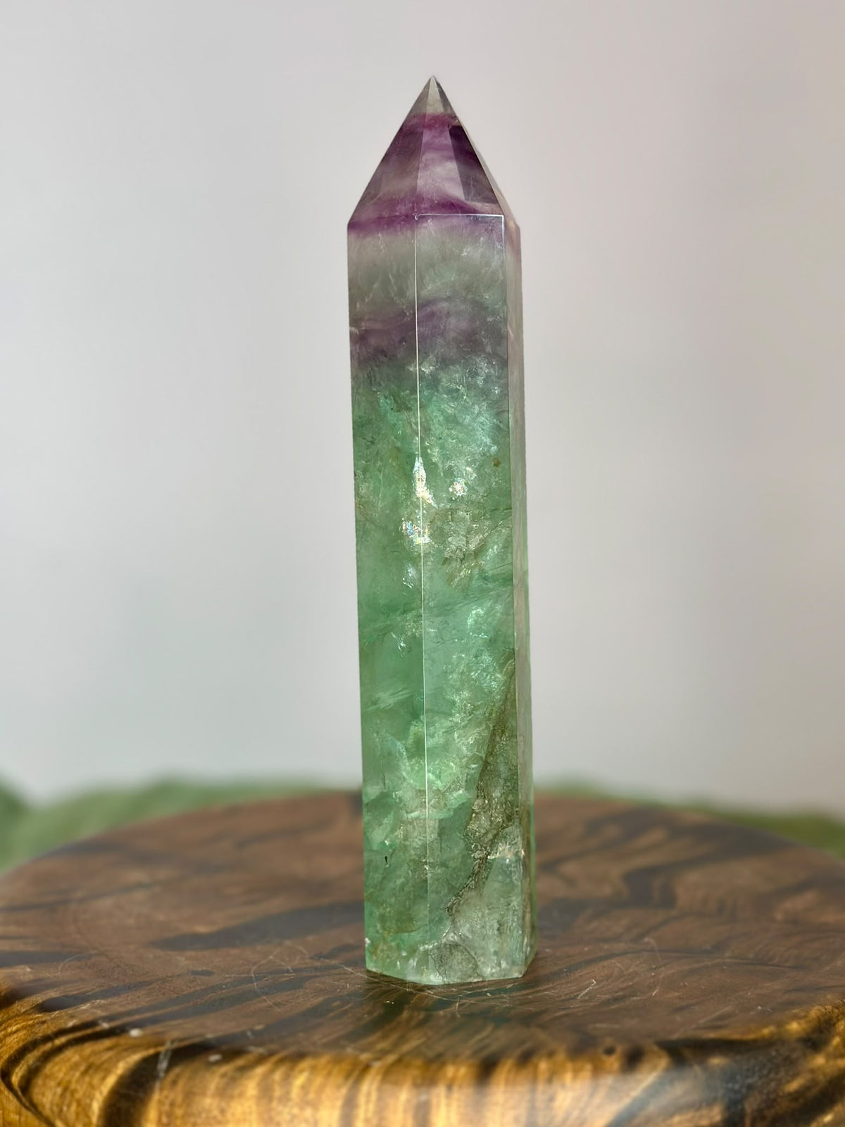 Large polished Rainbow Fluorite point with translucent green crystal and purple bands