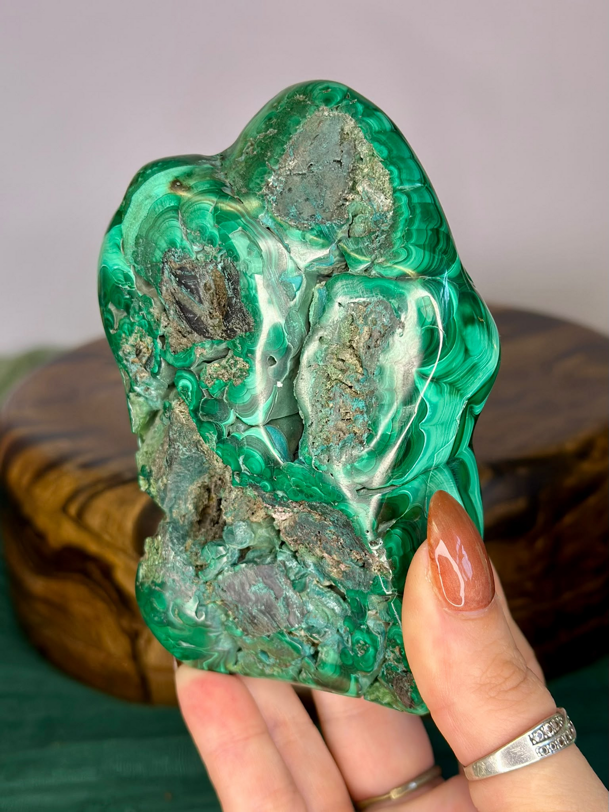 Reverse of polished Malachite freeform showing retained natural mineral formation