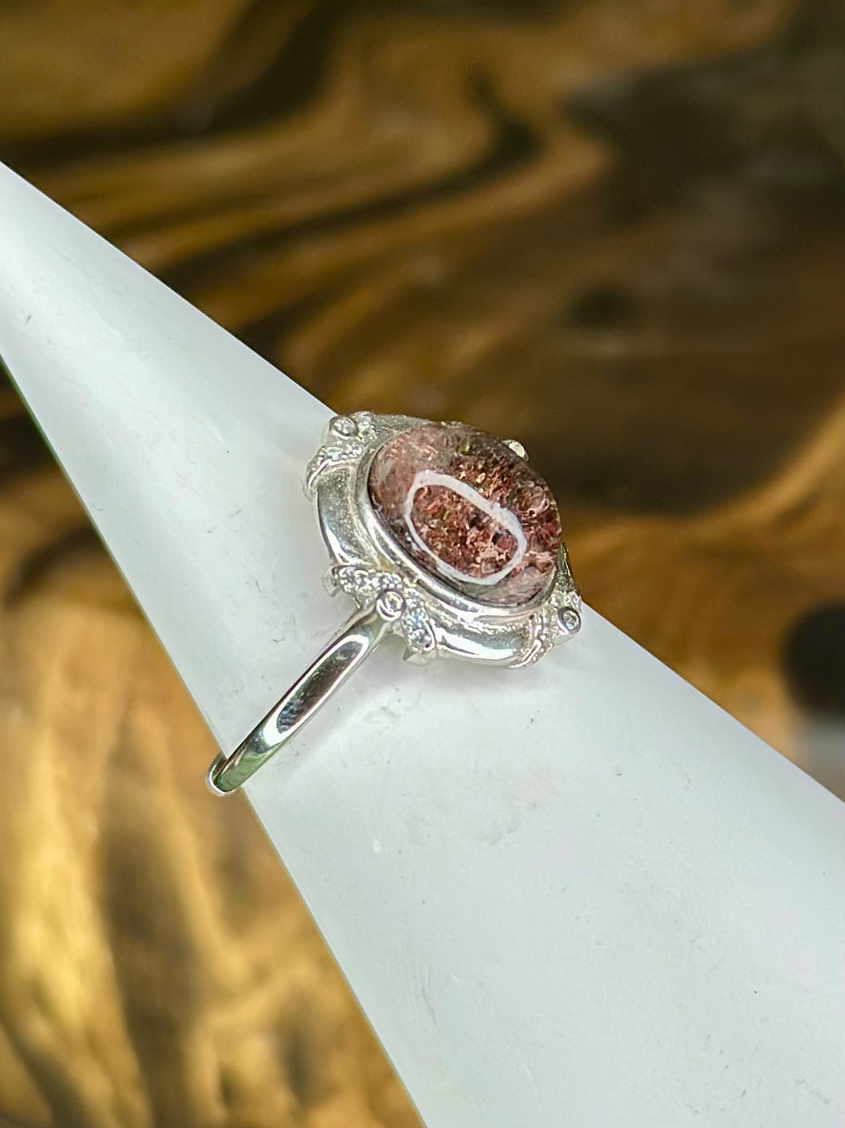 Side view of Red Garden Quartz sterling silver ring showing natural red and copper inclusions and ornate silver setting