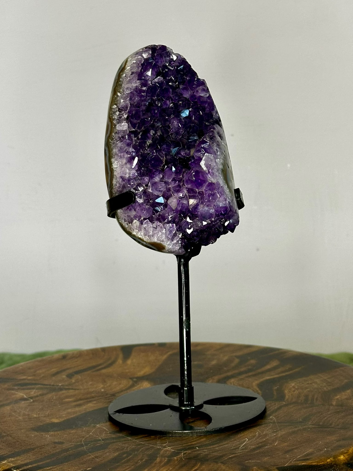 Natural Uruguay Amethyst crystal cluster mounted on black metal display stand